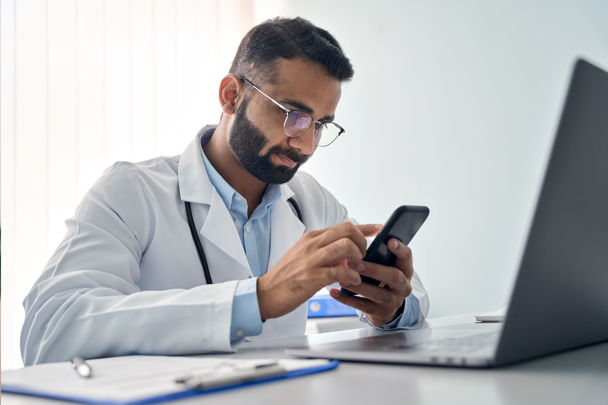 asian females using smartphones and taking notes eating healthy - Recuro Health | Making Advanced Healthcare Accessible™