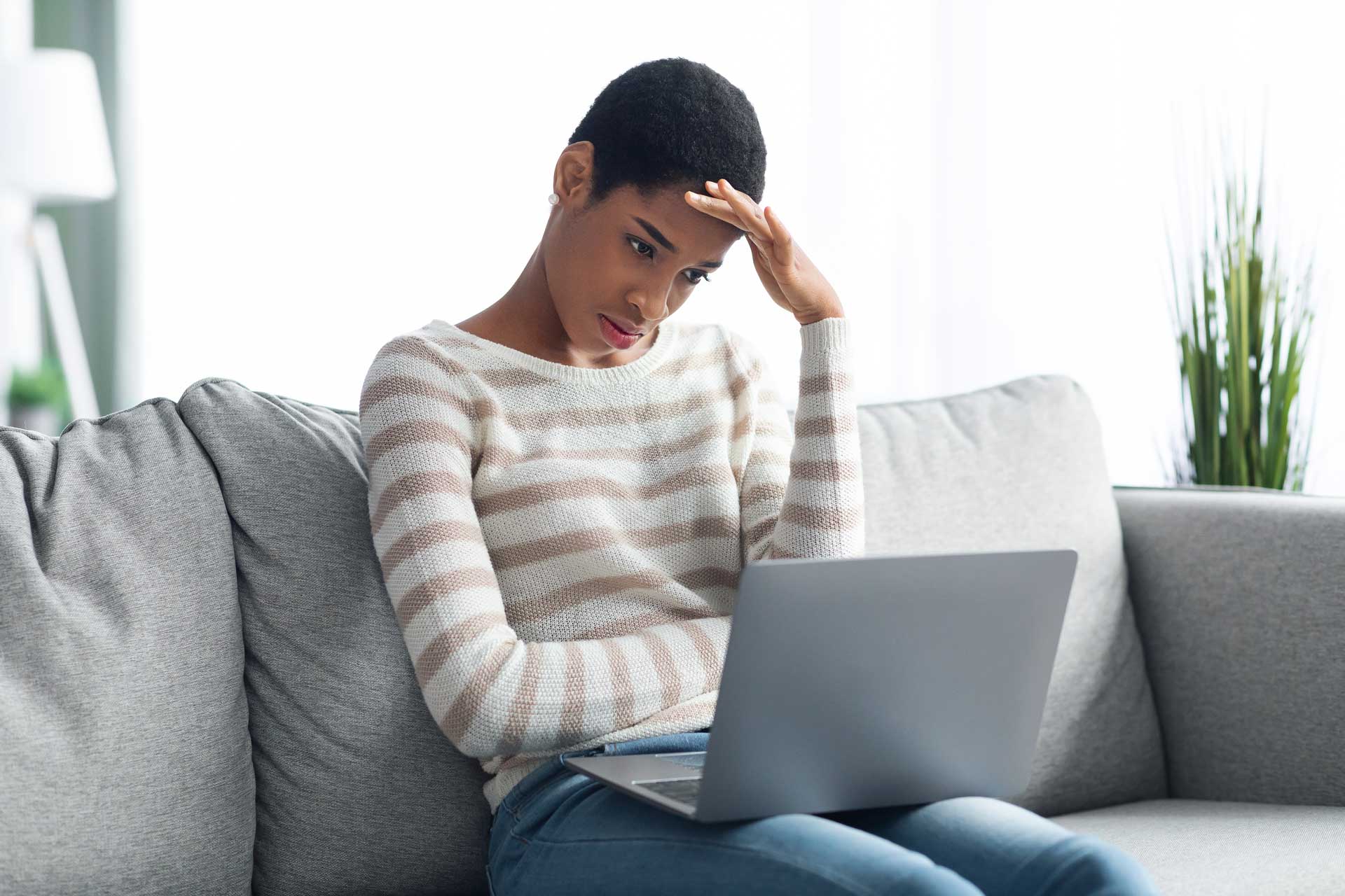 Woman looking stressed at laptop